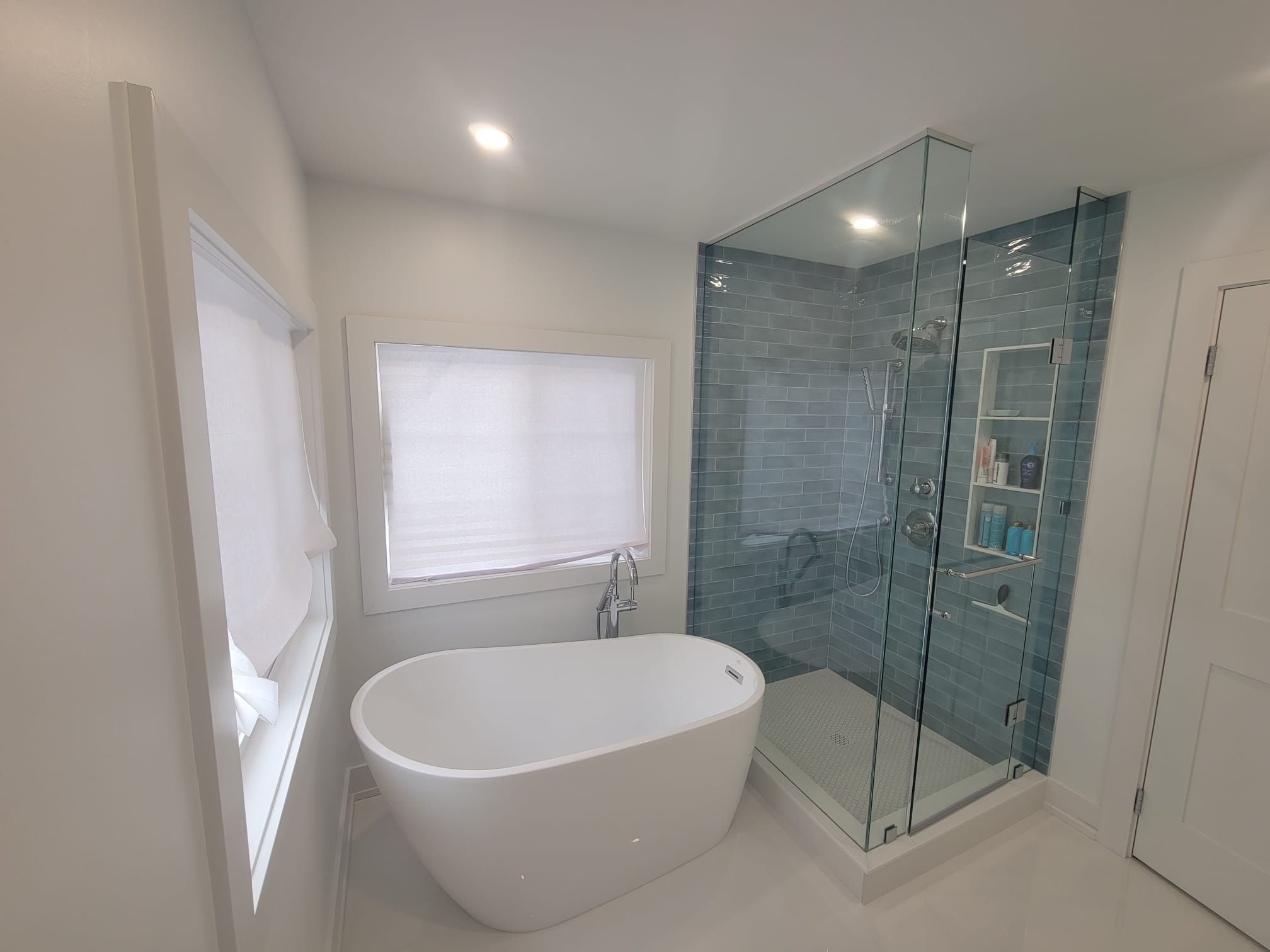 Freestanding tub with glass walk-in shower enclosure
