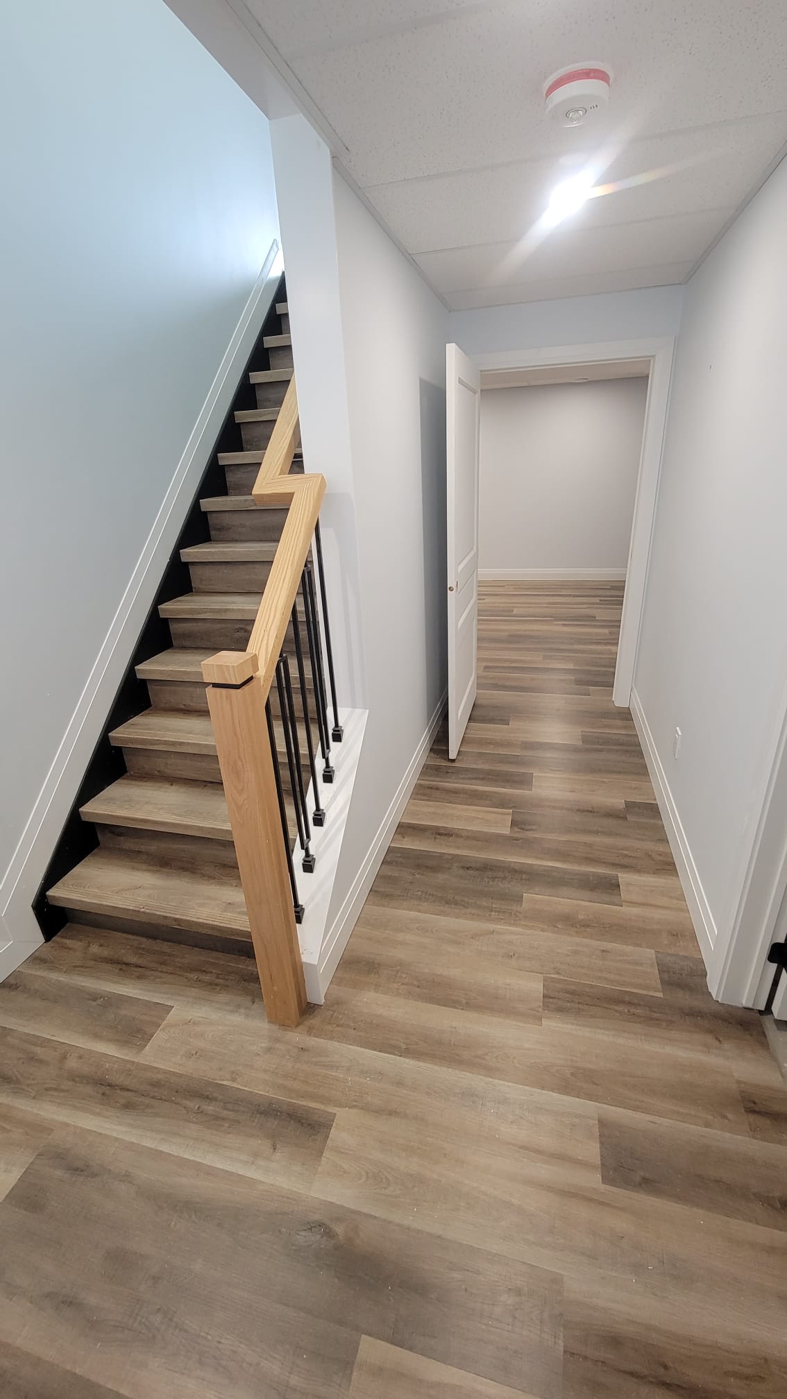 Basement staircase with dark wood treads