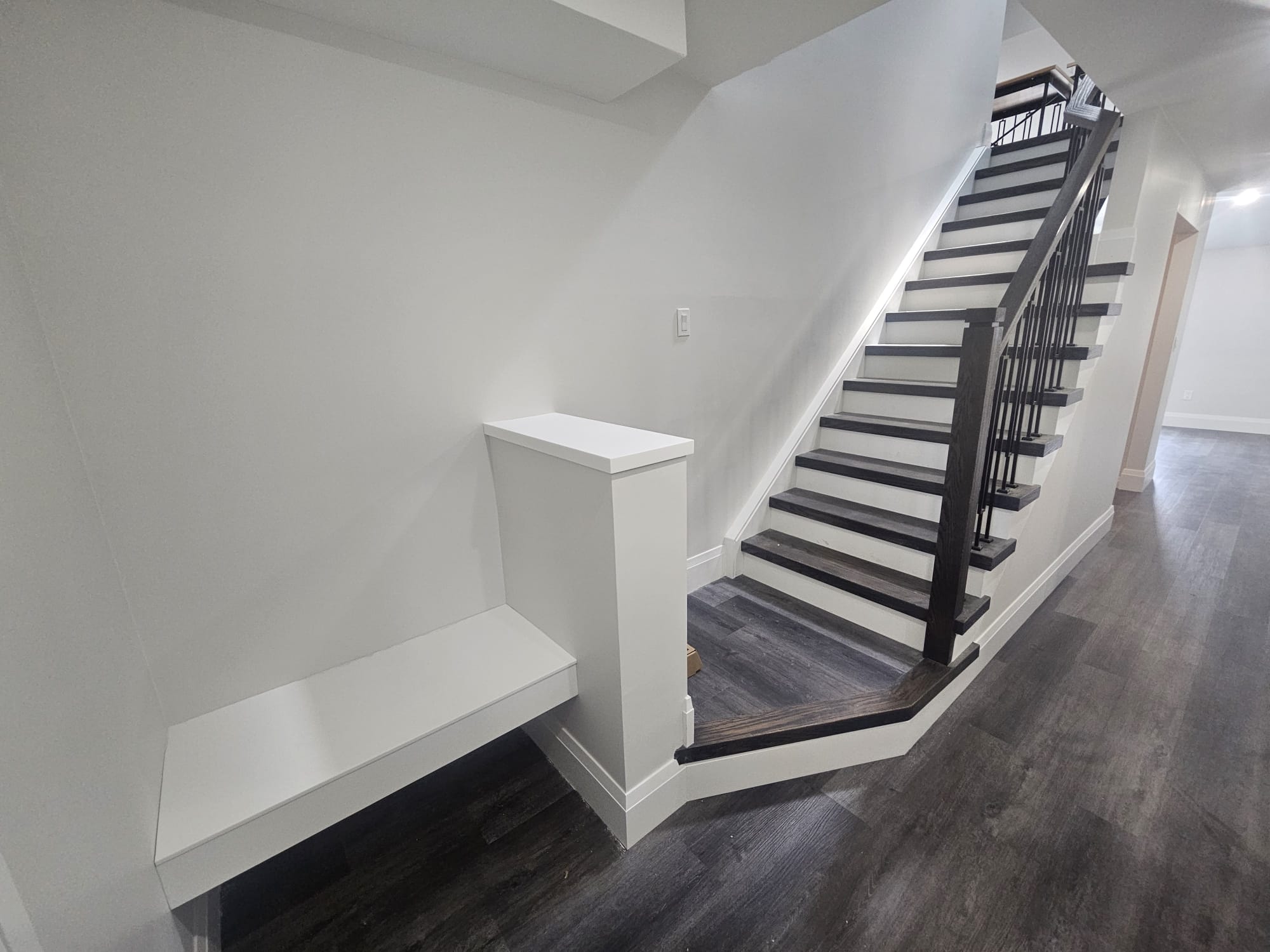 Staircase featuring built-in bench seating on landing