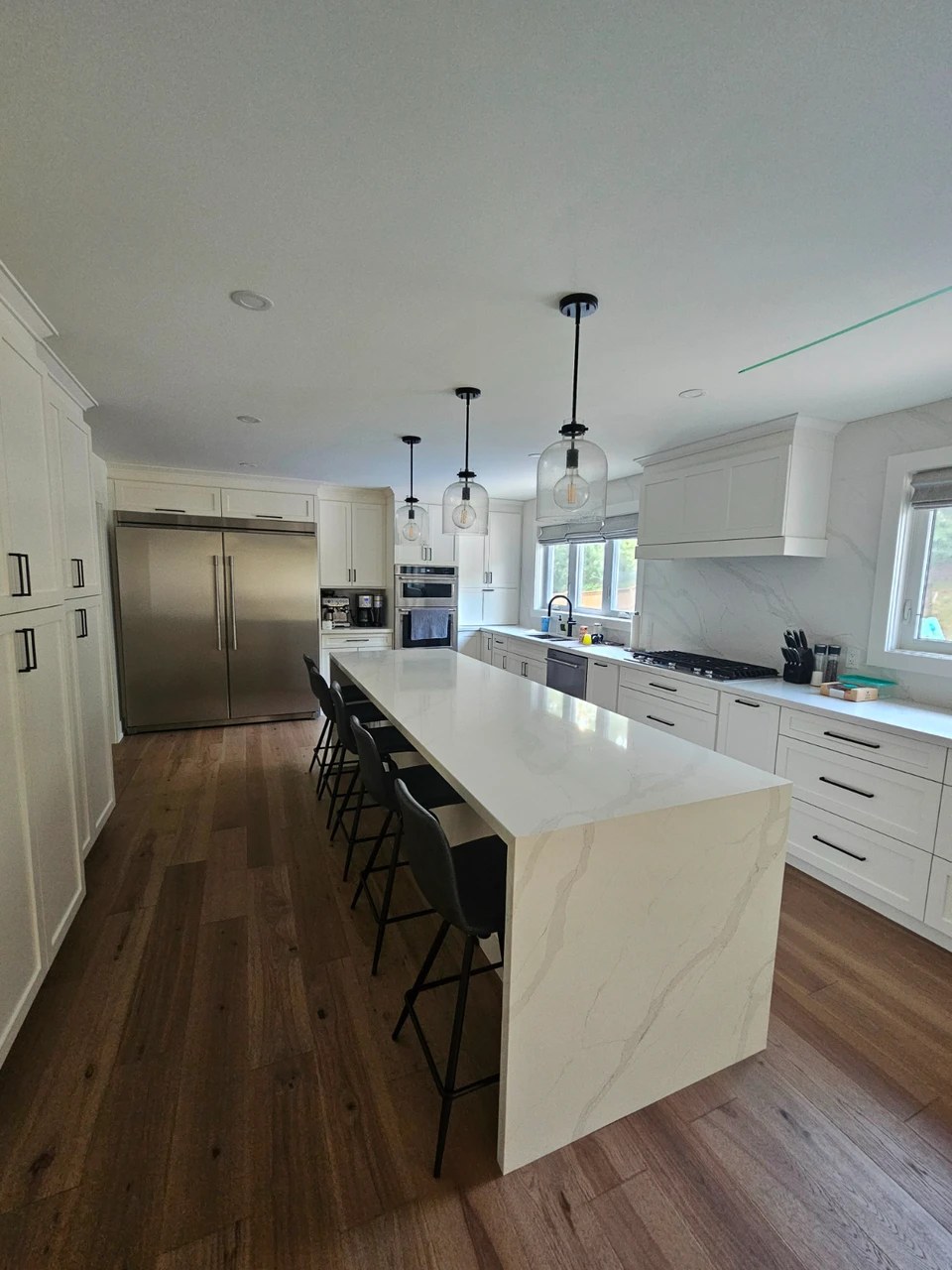 Kitchen island with seating and white cabinetry