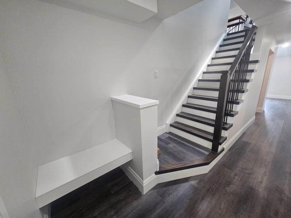 Custom staircase with dark wood treads and black balusters