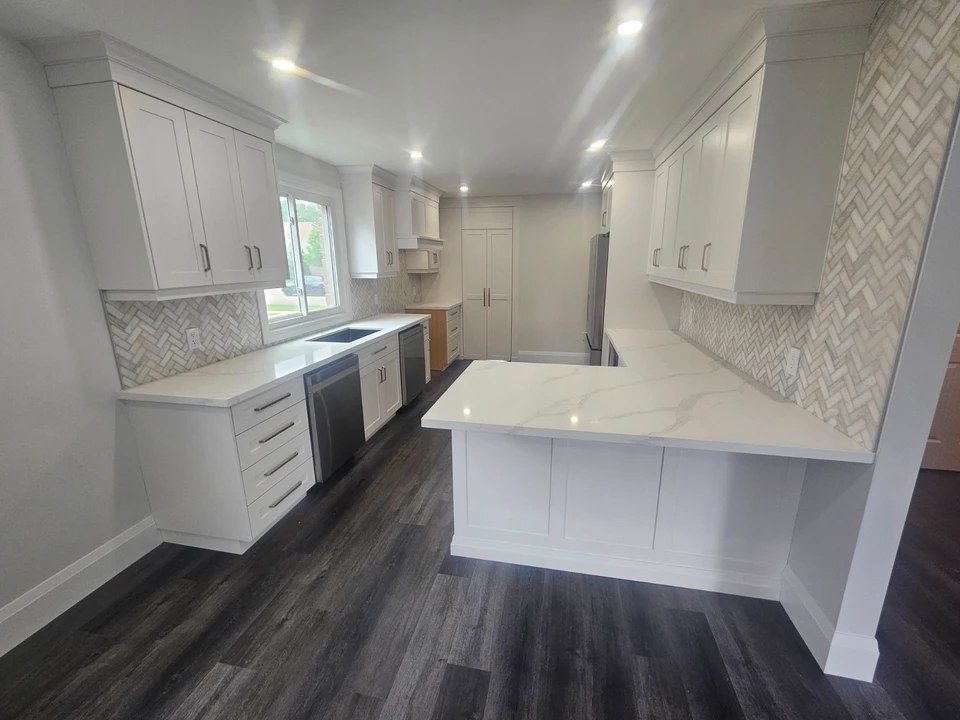 Full white kitchen remodel with quartz counters and island